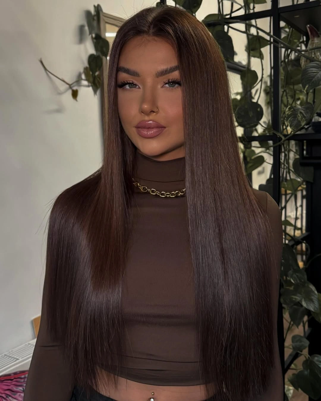 Very long sleek dark brown hair with soft face-framing pieces