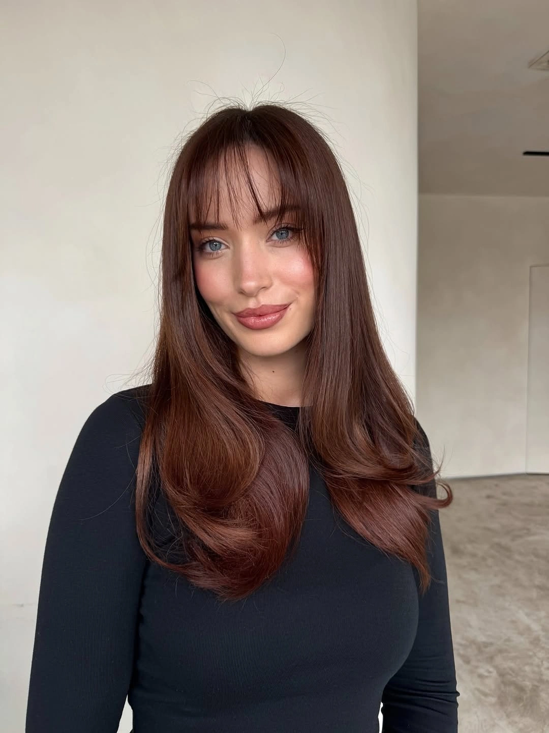 Long medium brown hair in glossy waves with curved front pieces
