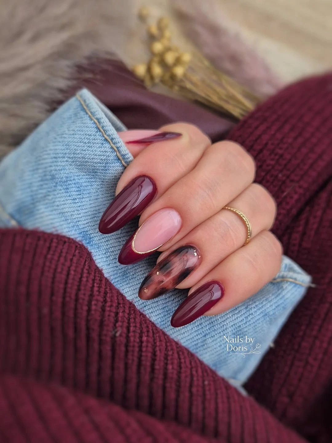 long almond burgundy nails with blush and smoky marbled accents