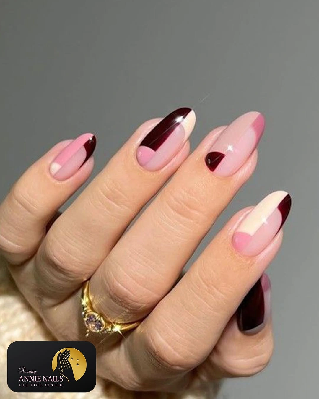 medium almond nails with blush pink and burgundy curved tips