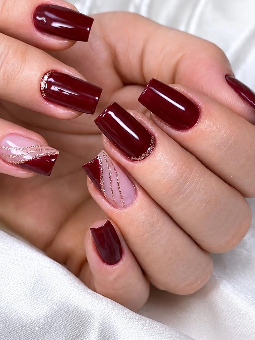 short burgundy nails with one blush textured accent nail