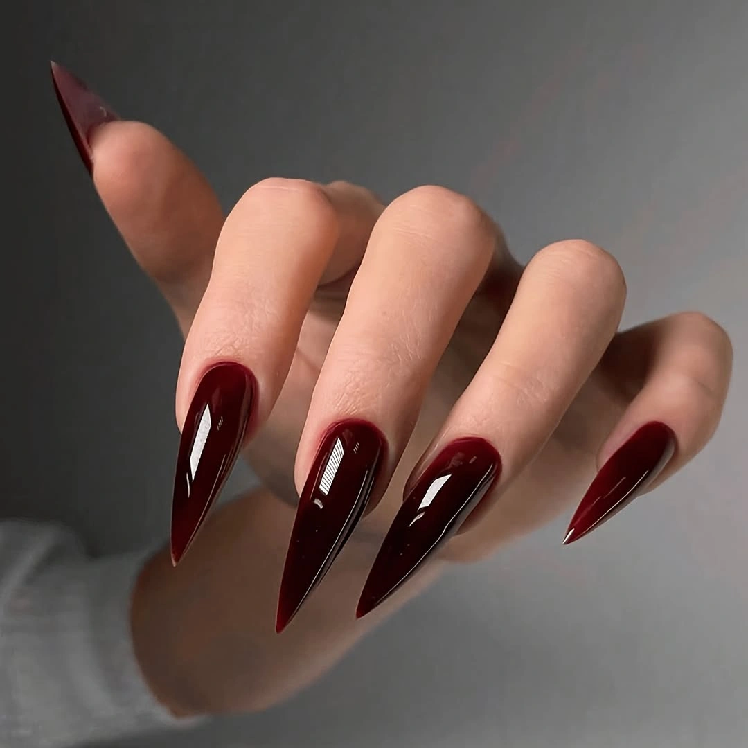 very long stiletto nails in deep glossy burgundy