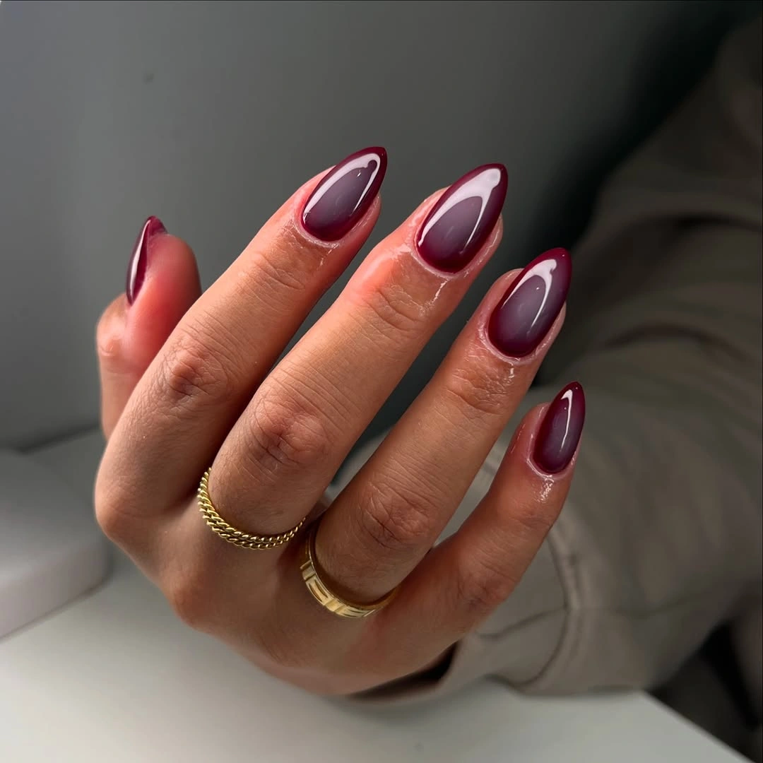 medium almond burgundy nails with pale outlined centers