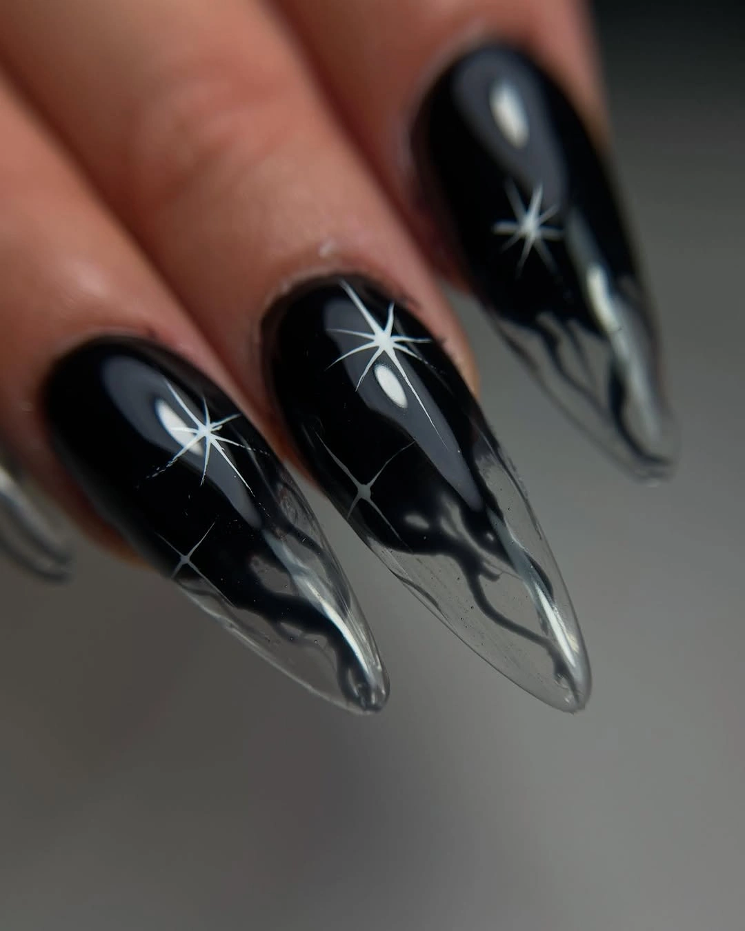 black stiletto nails with white starburst lines