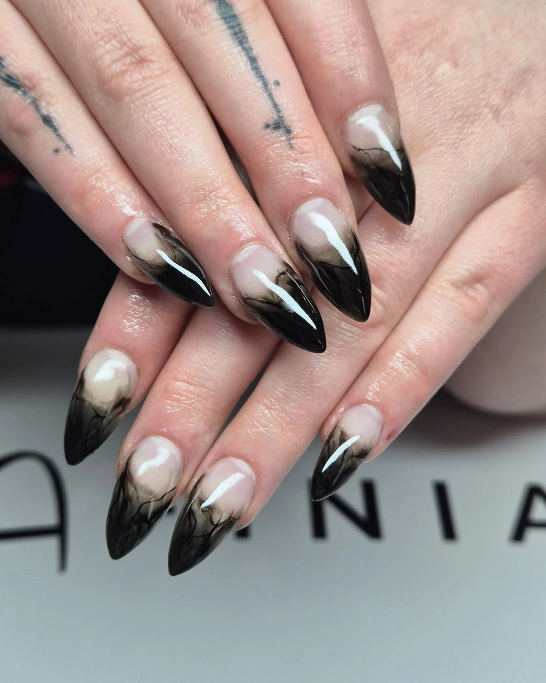 black white pointed nails with open curved tips