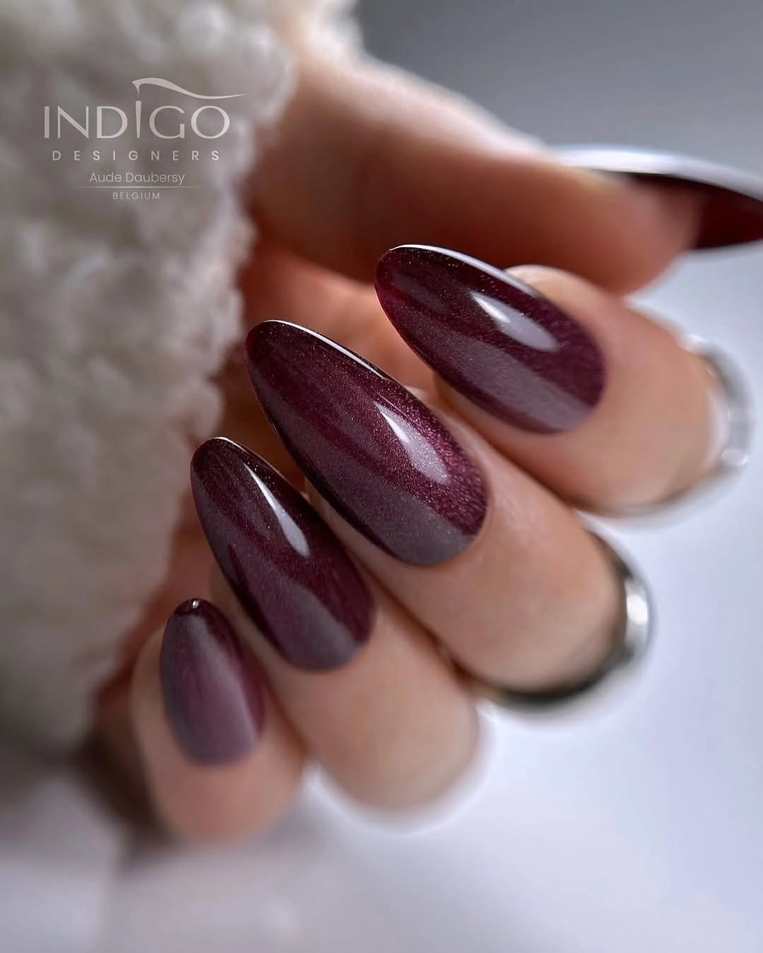 plum burgundy almond nails with reflective shine