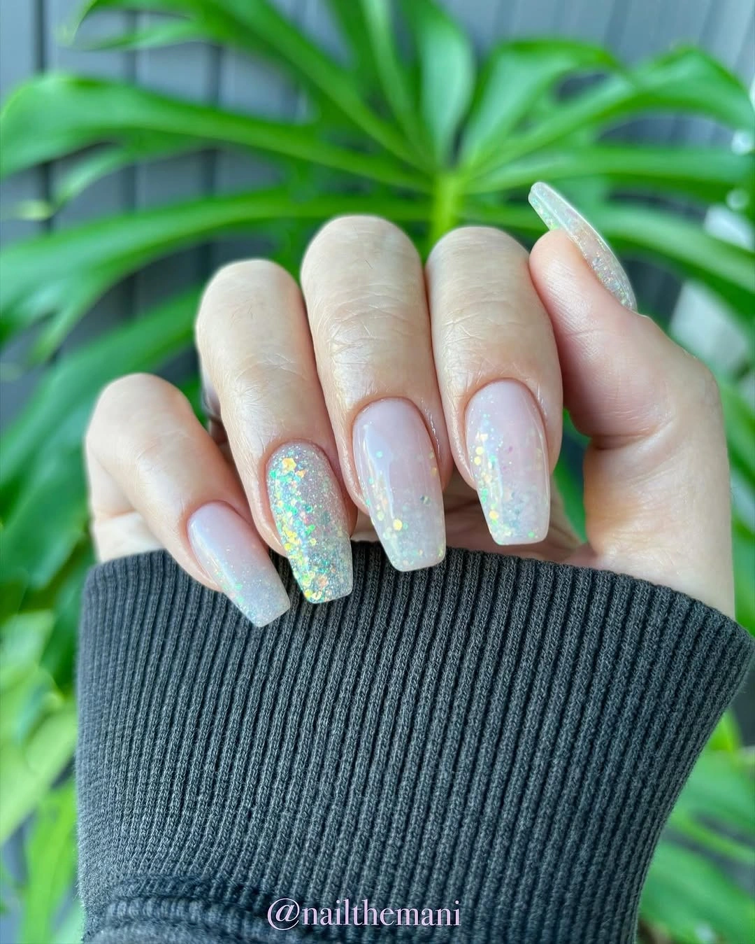 Long square nails with a milky white fade and iridescent sparkle