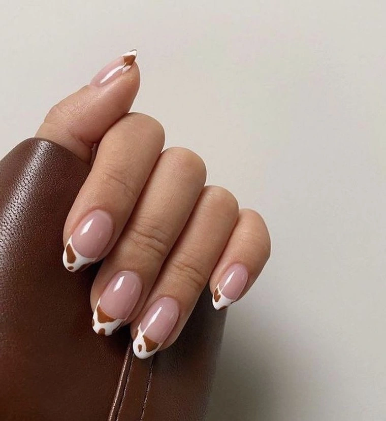 Medium nude almond nails with tiny white curved French tips