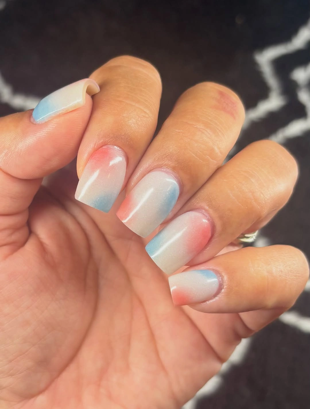 Pale nude almond nails with coral and aqua wavy French tips