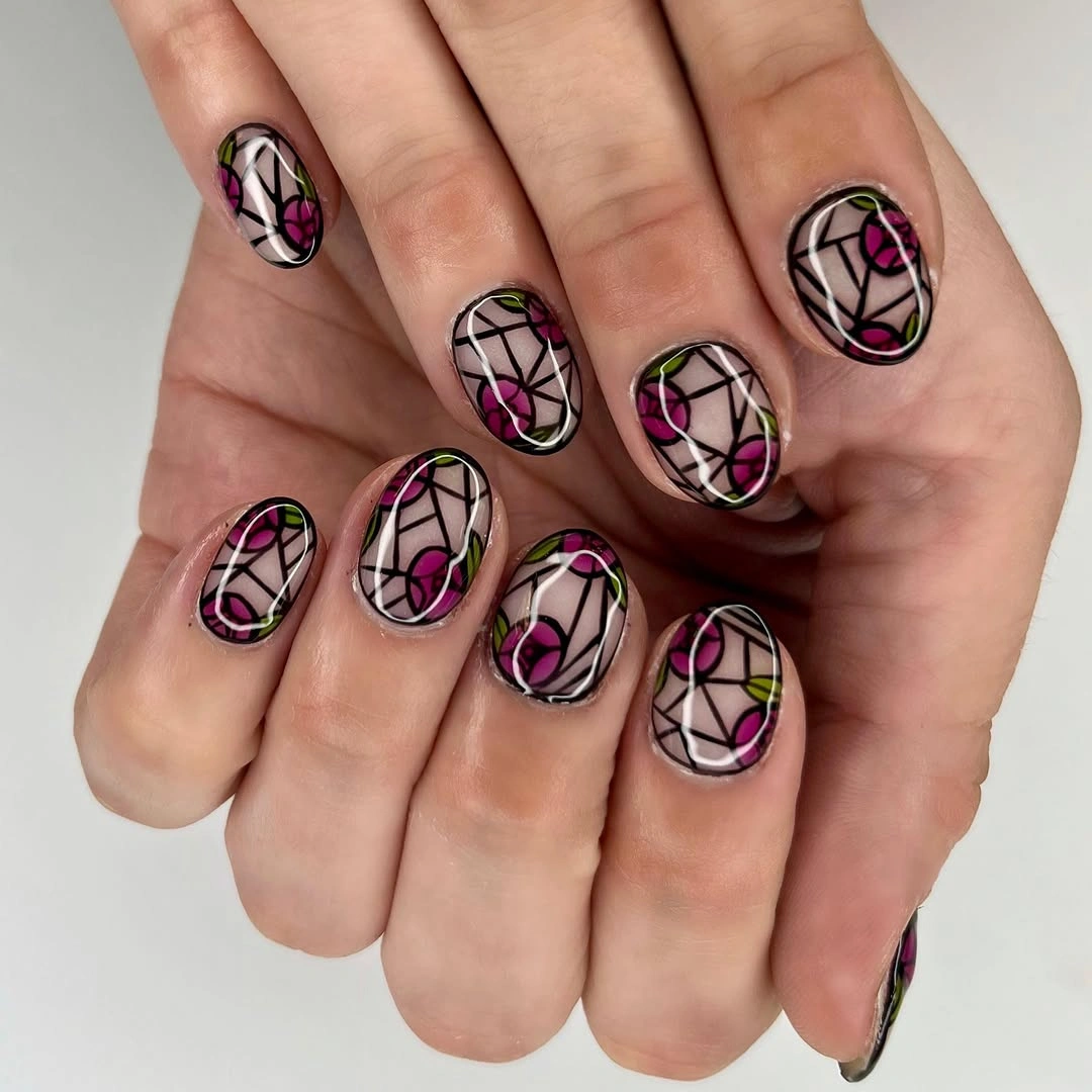 Short nude nails with black outlined stained-glass floral motifs