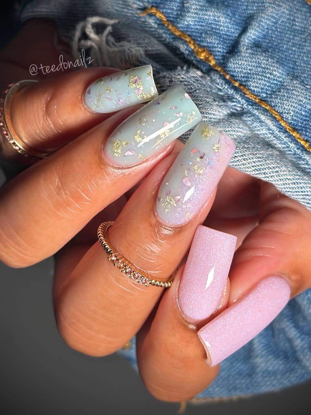 Milky square nails with pale blue French sections and gold flecks