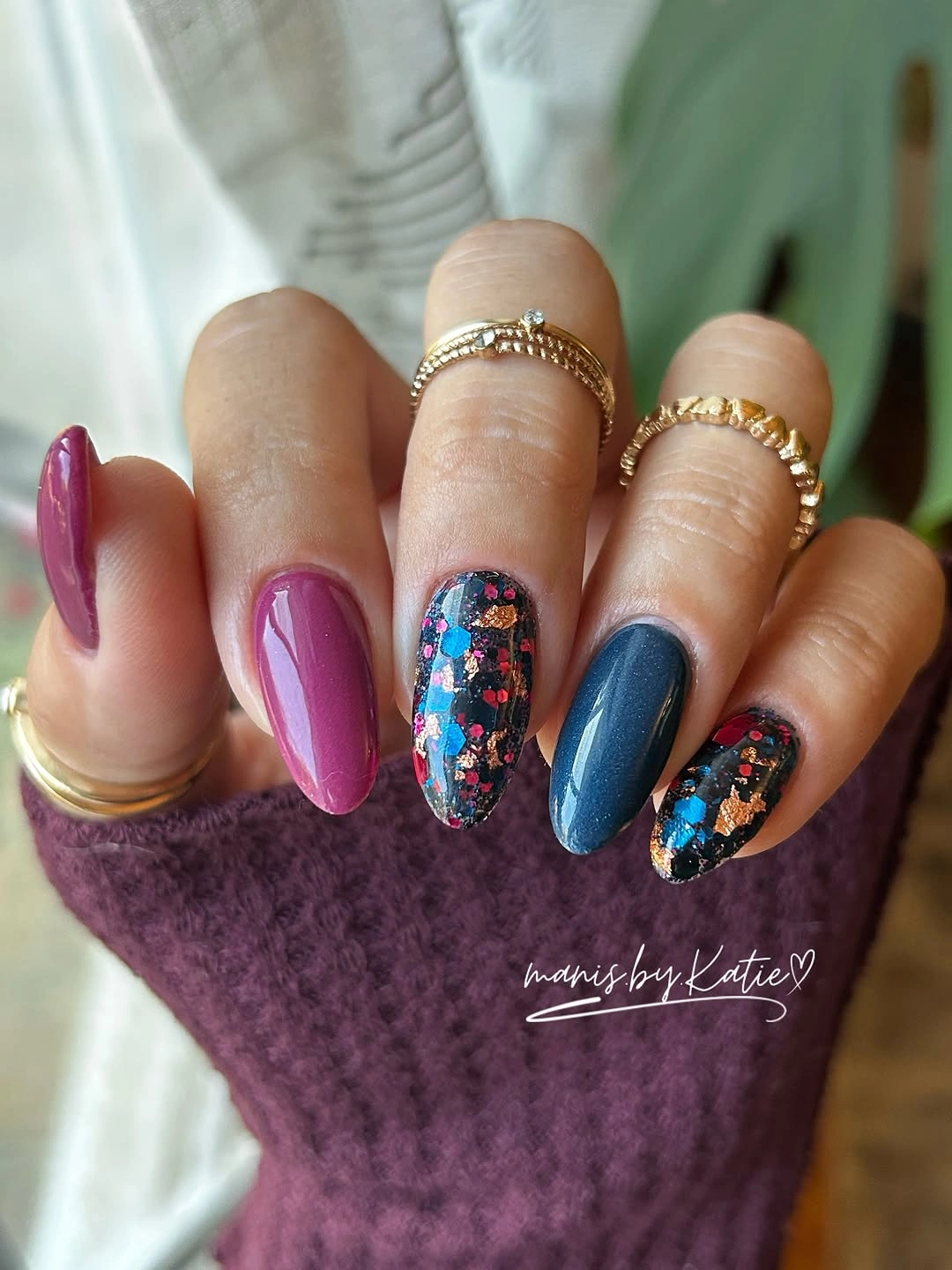 Long stiletto nails in cobalt, magenta, and multicolor floral accents