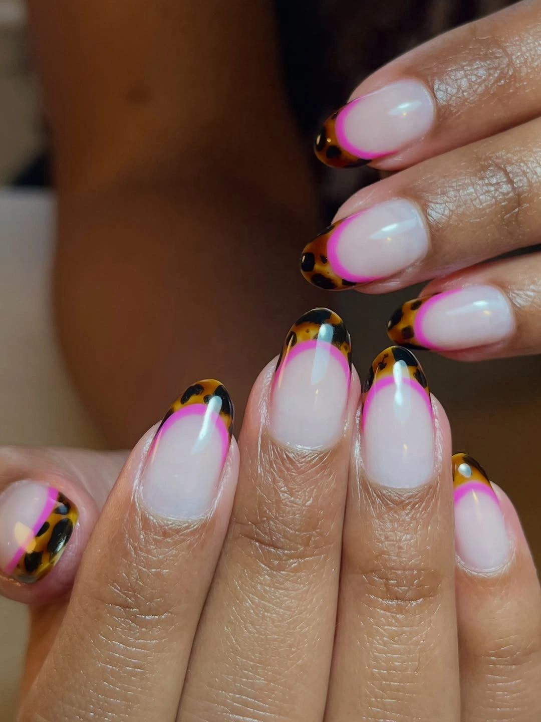 Short almond milky nails with thin multicolor rainbow French edges