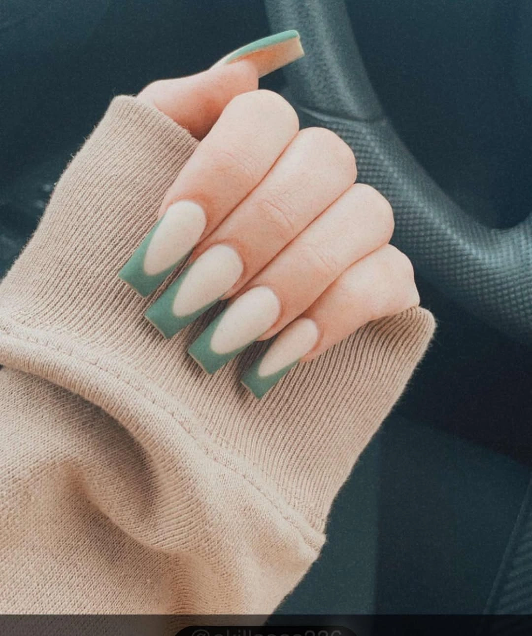 Medium almond nails with sage green French tips and pale bases