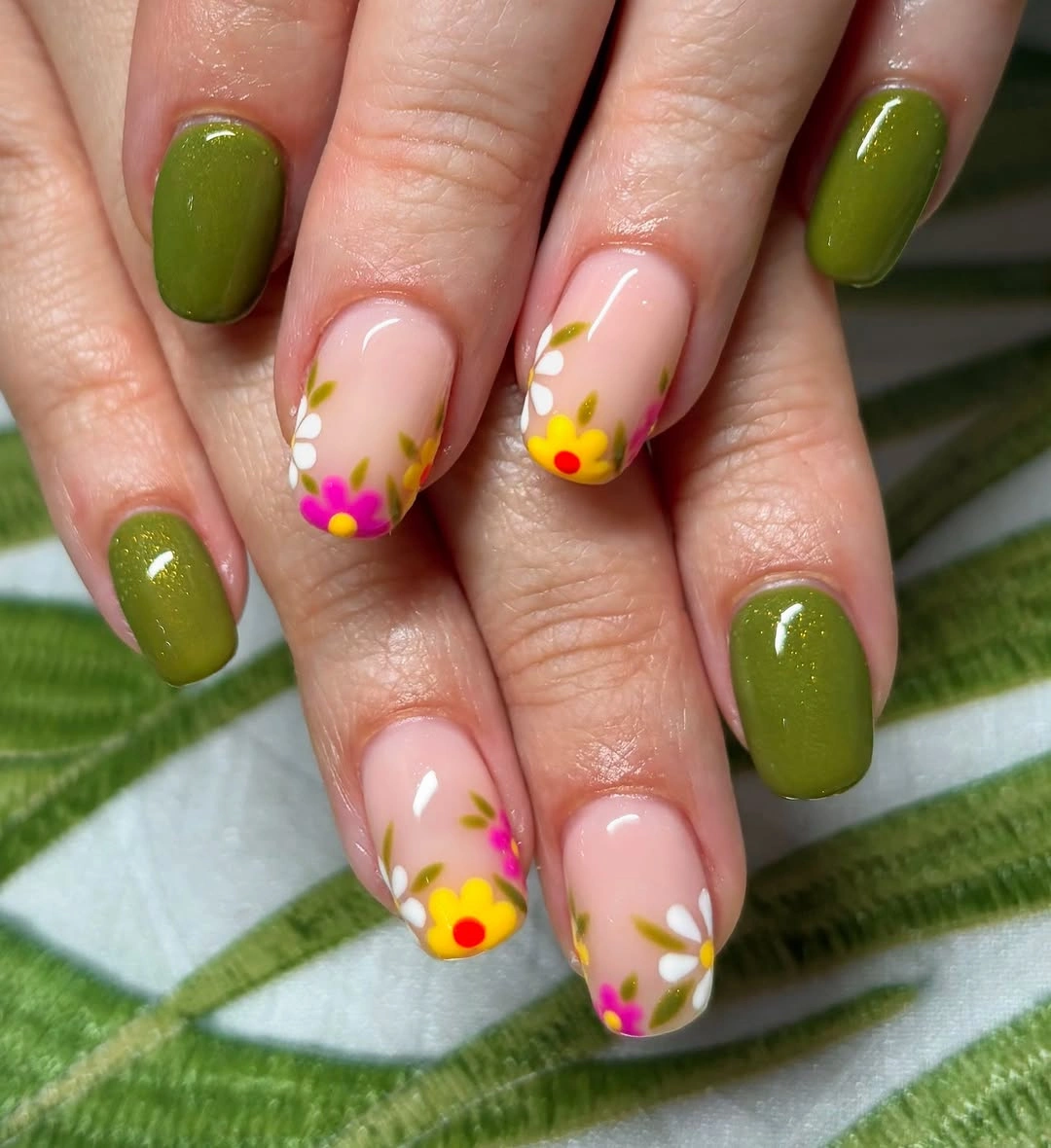 Olive rounded nails with pale pink flower accents