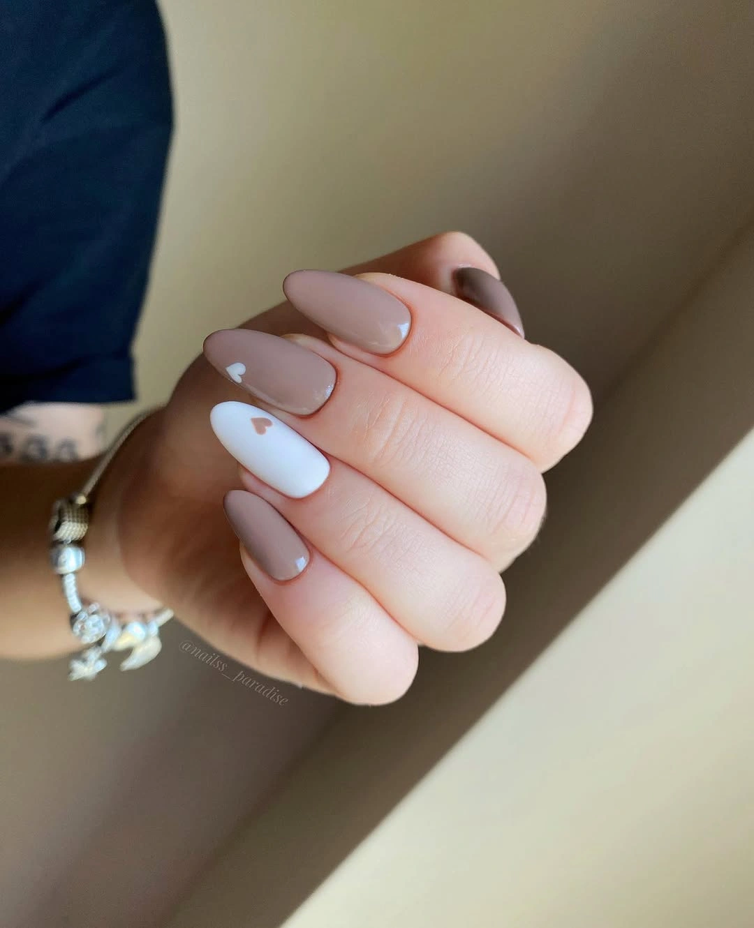 Soft pink almond nails with pale white side accents