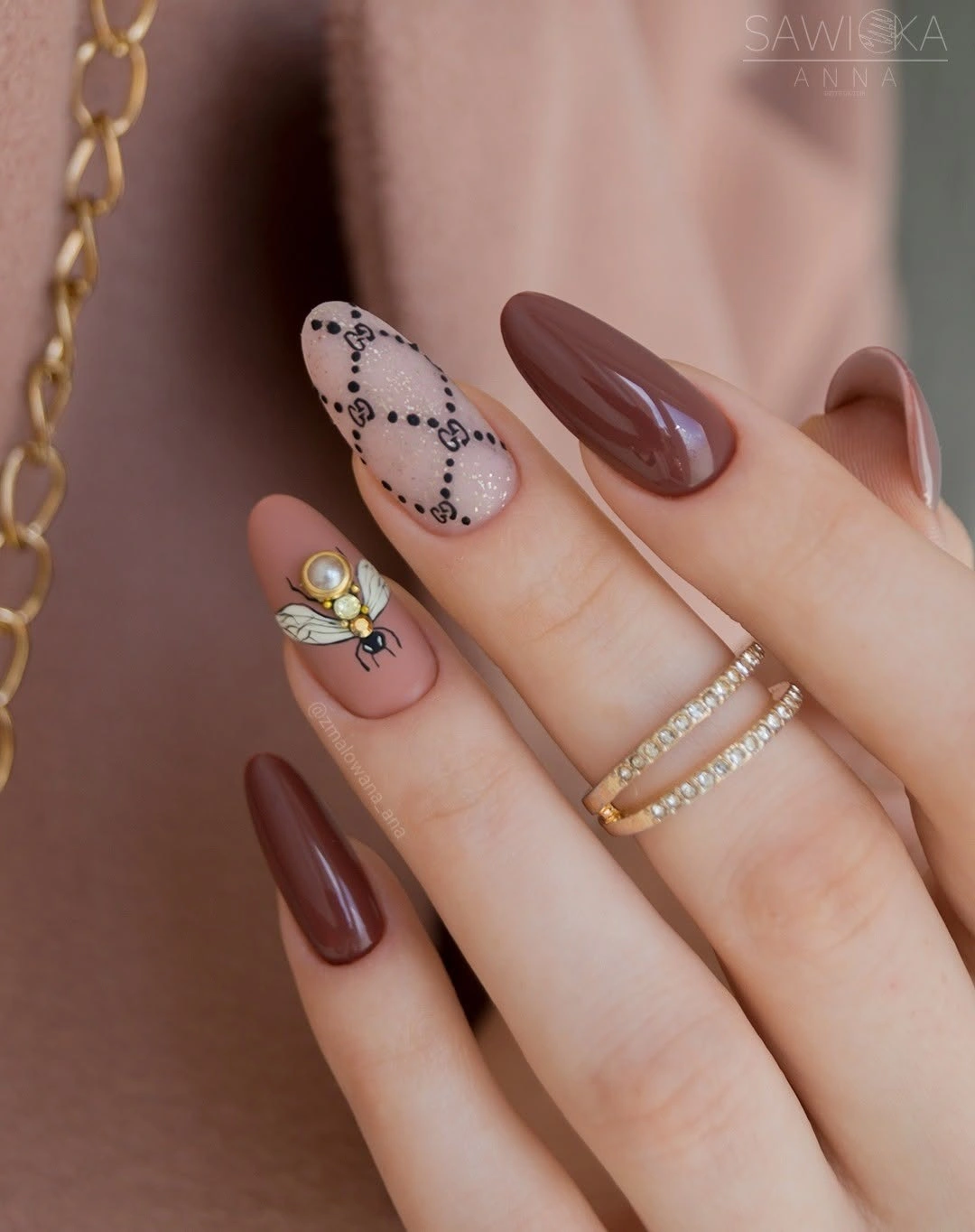 Brown almond nails with pale dotted loop accents