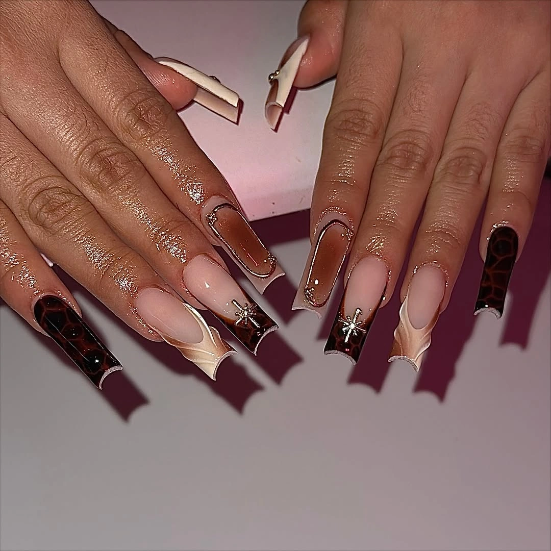 Long purple pink ombre nails with translucent tips glitter and gold flakes