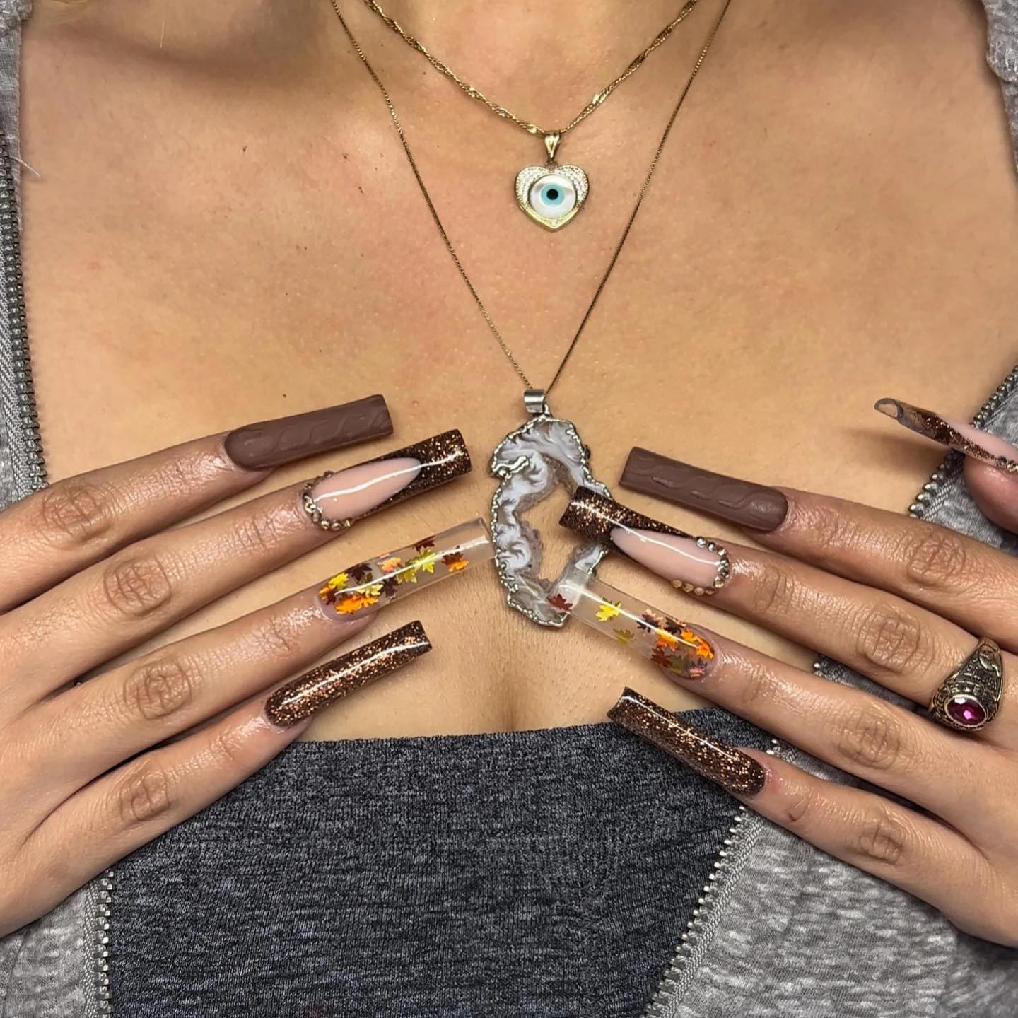 Long nude nails with pale blue dotted panels and tiny star accents