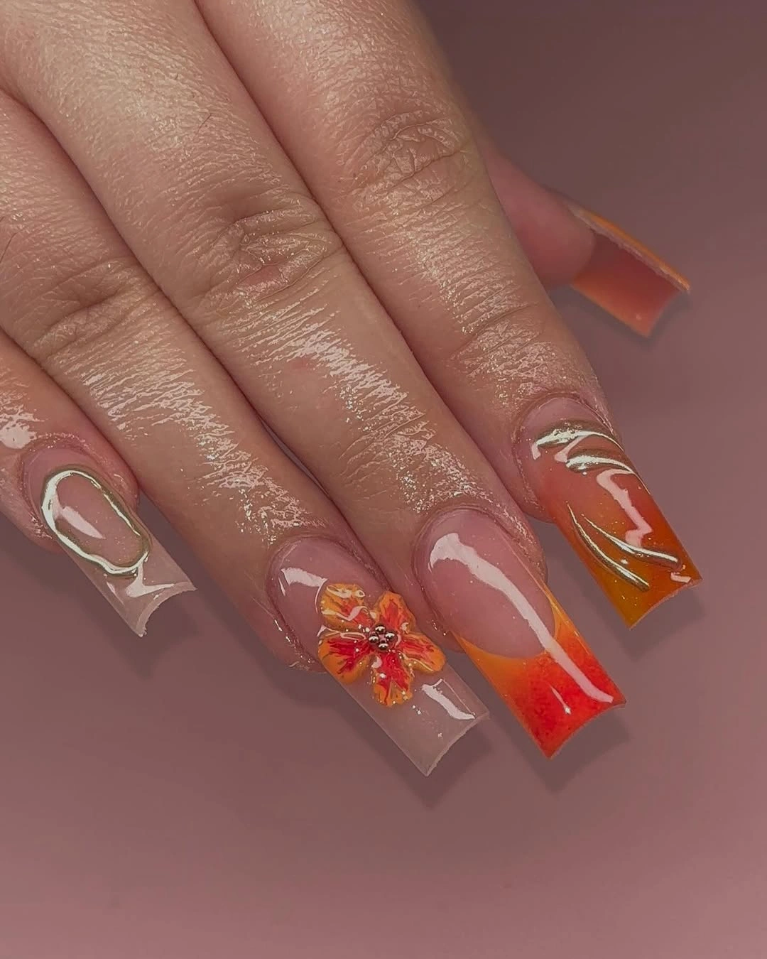 Long black stiletto nails with nude leopard panels and red accents