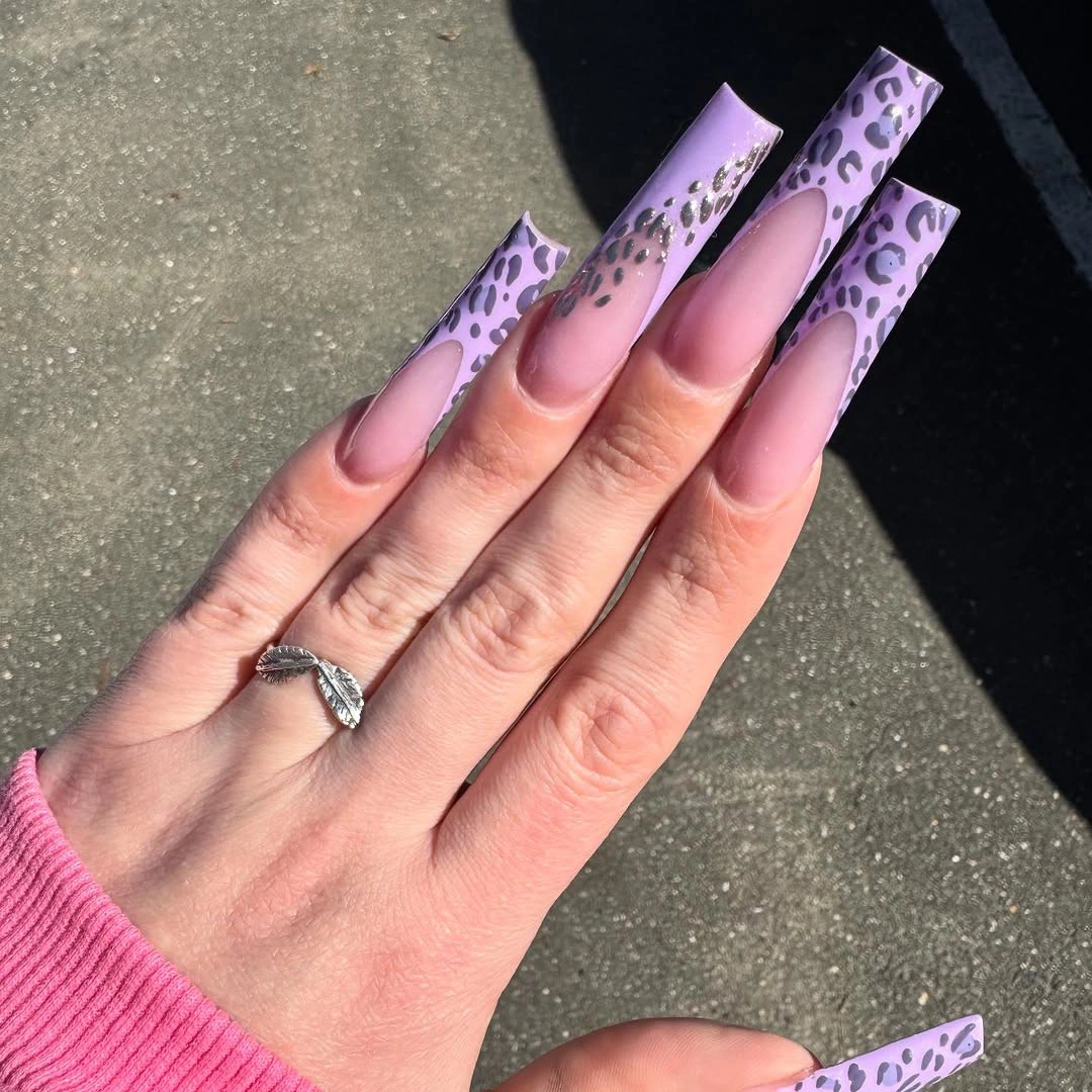 Long almond nails with silver chrome curves over a sheer nude base