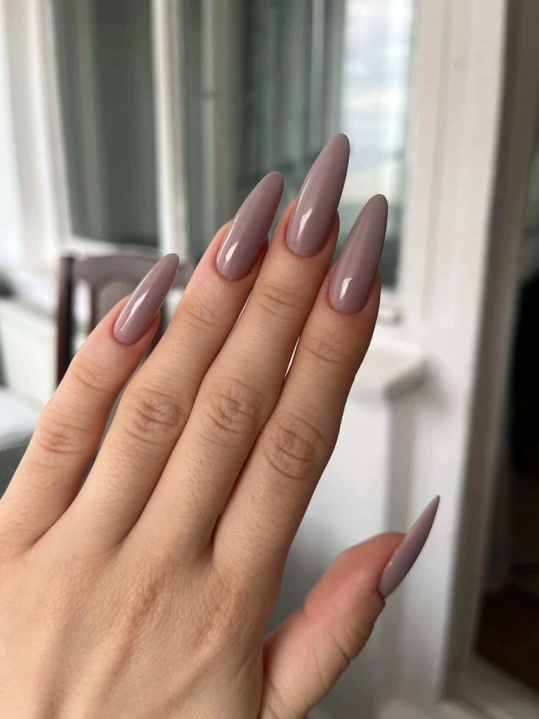 Long square nails with nude pink bases tortoise panels and tiny star accents
