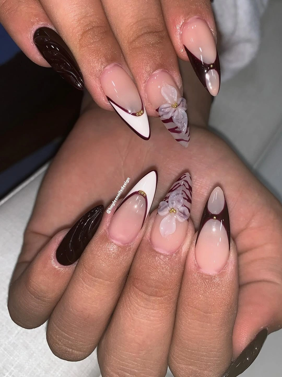 Medium nude almond nails with glossy pointed red French tips