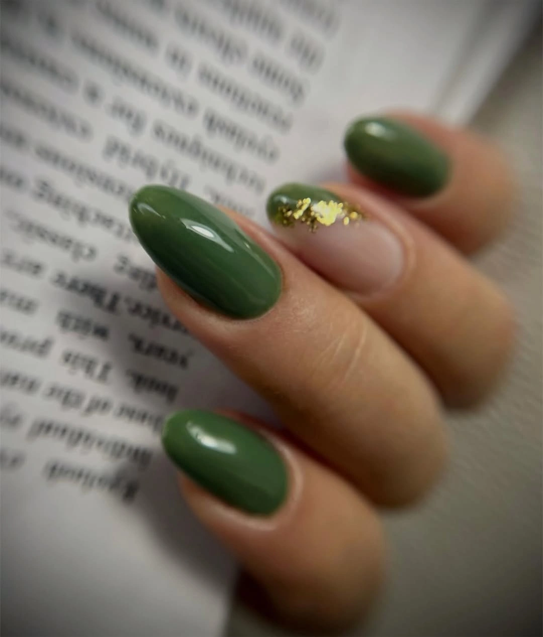 Forest green oval nails with gold fleck accent