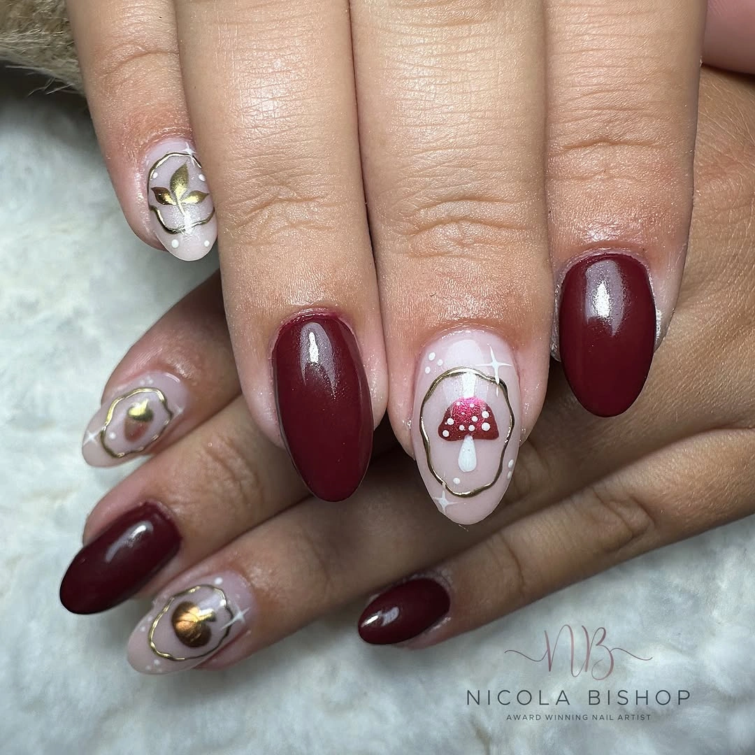 Burgundy oval nails with mushroom and leaf accents