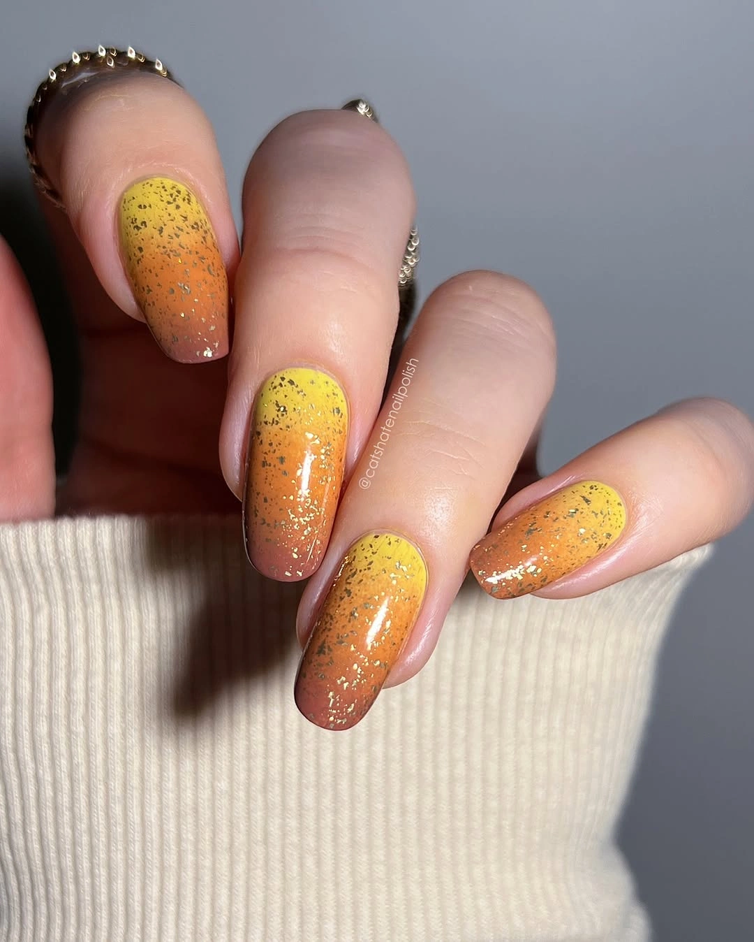 Yellow orange gradient nails with gold speckles