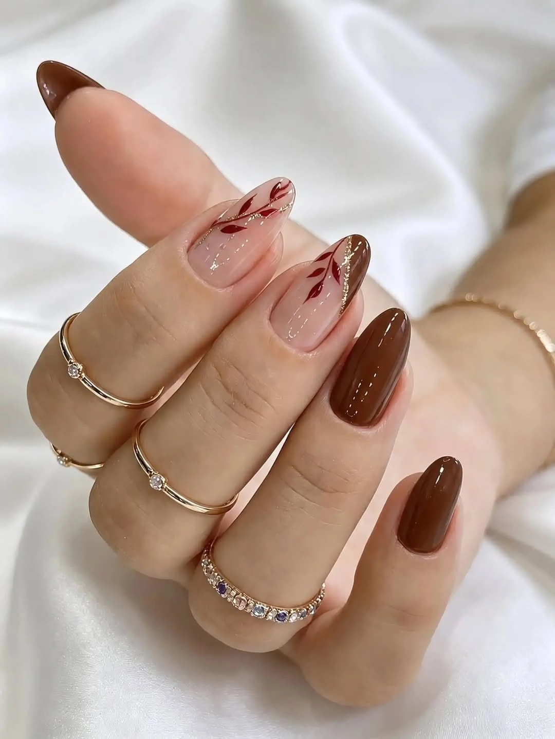 Cocoa brown almond nails with leafy accents