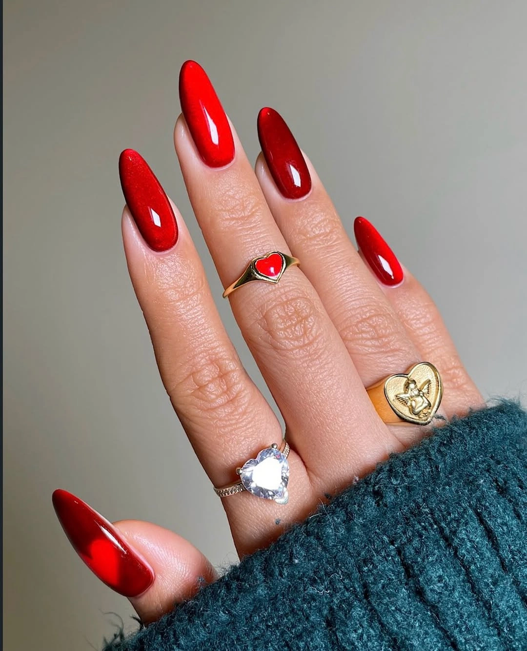 Glossy red almond nails in a saturated fall shade