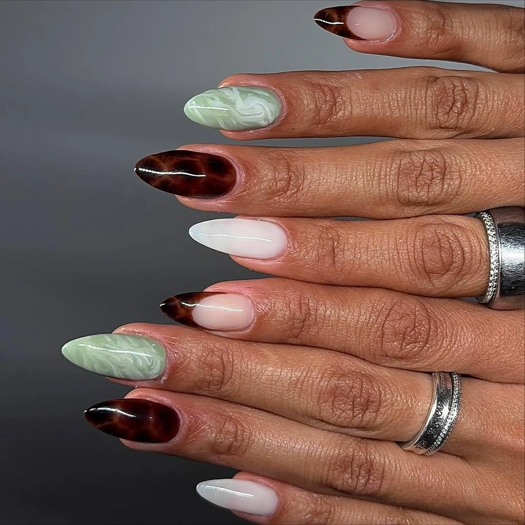 Brown green and white almond nails with marbled accents
