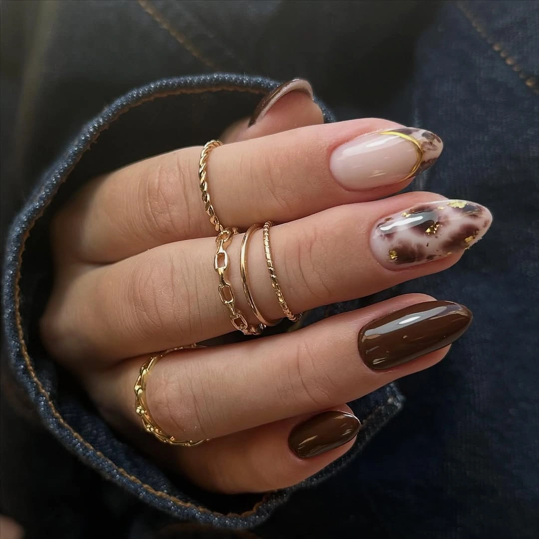 Medium almond chocolate brown nails with a marbled accent