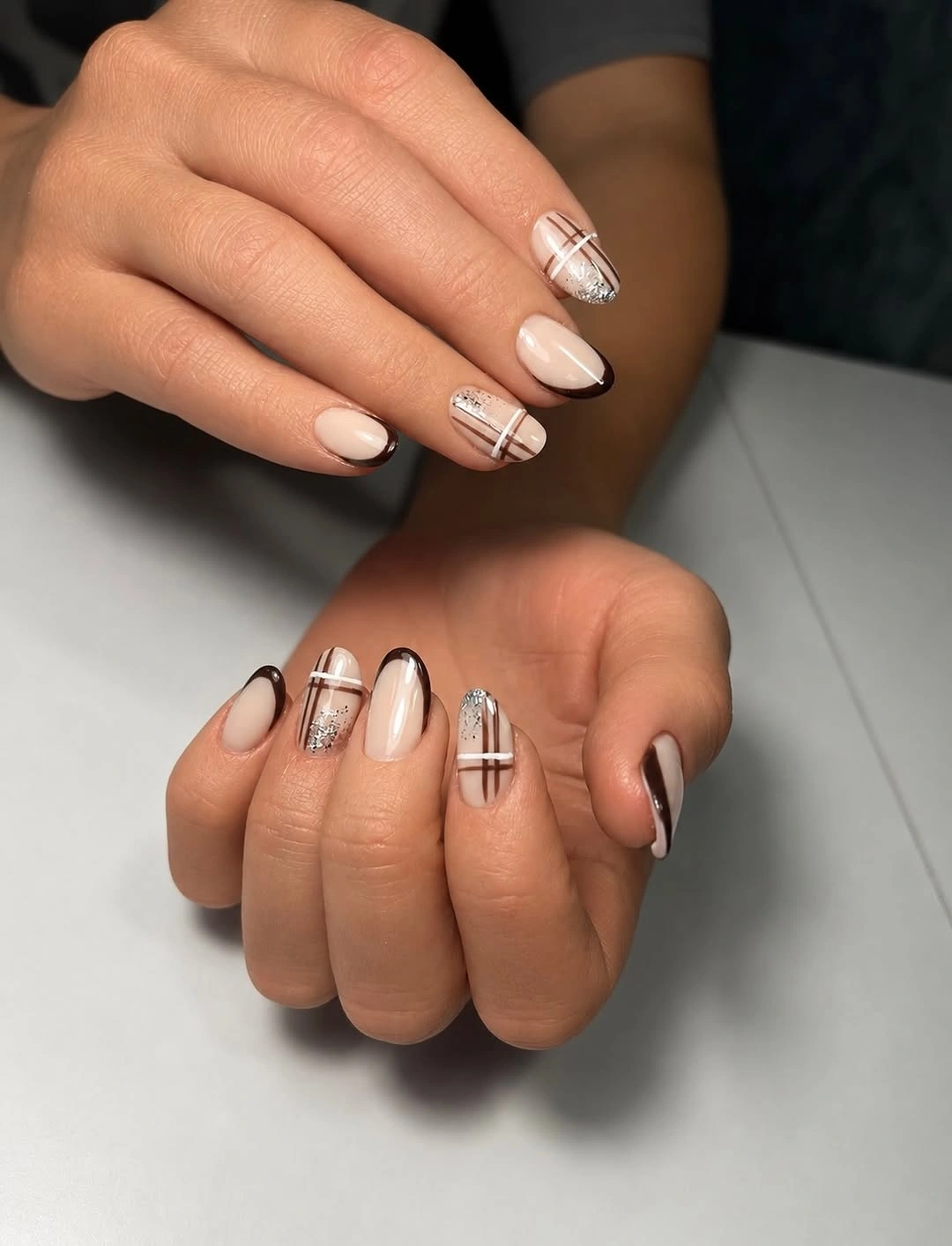 Medium almond nude nails with black white and copper geometric lines
