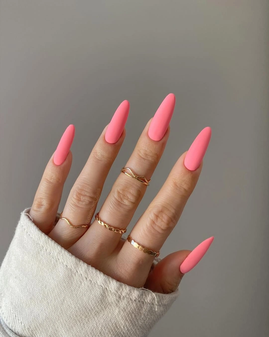 Very long saturated hot pink matte stiletto nails