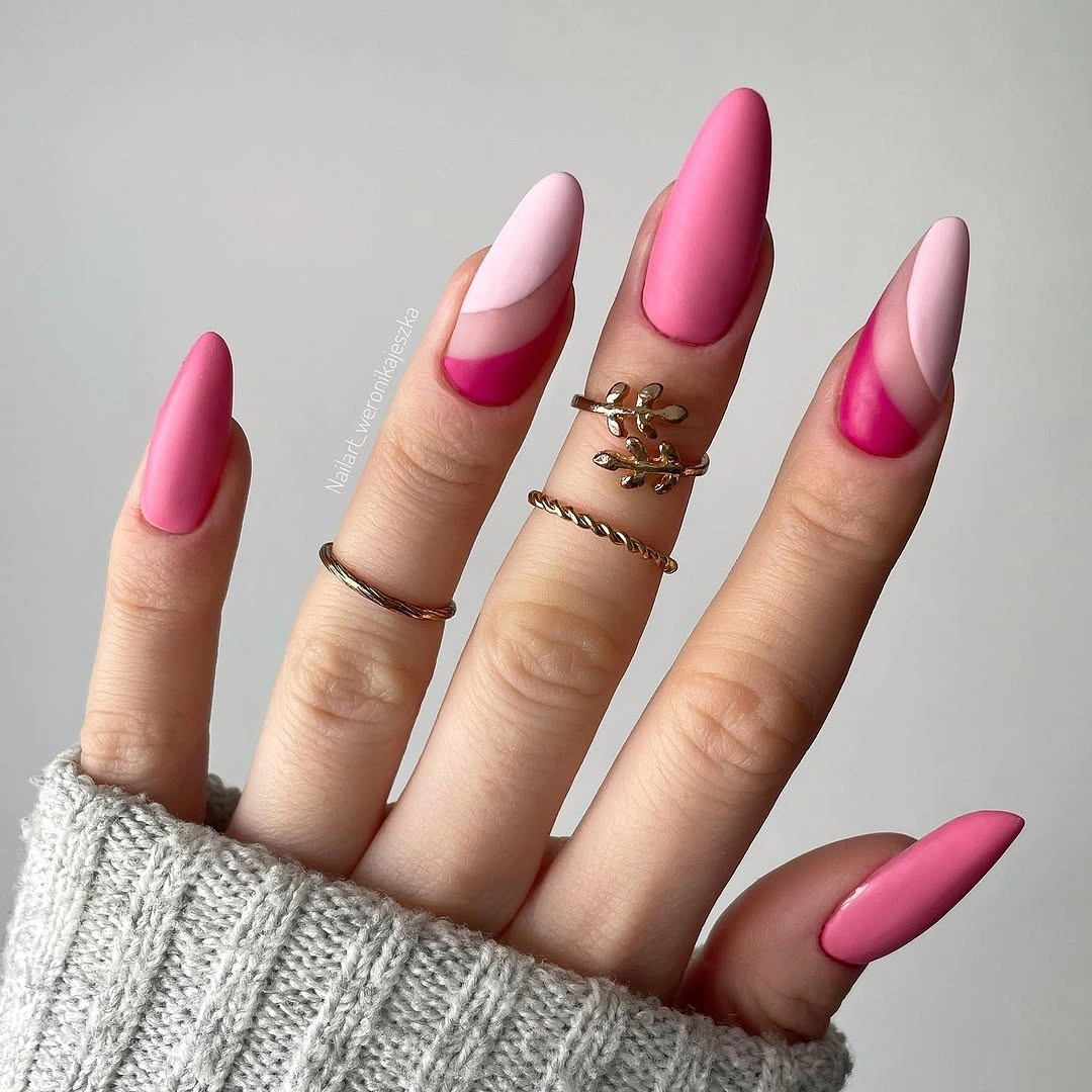 Long pink and white almond nails with vivid curved tips