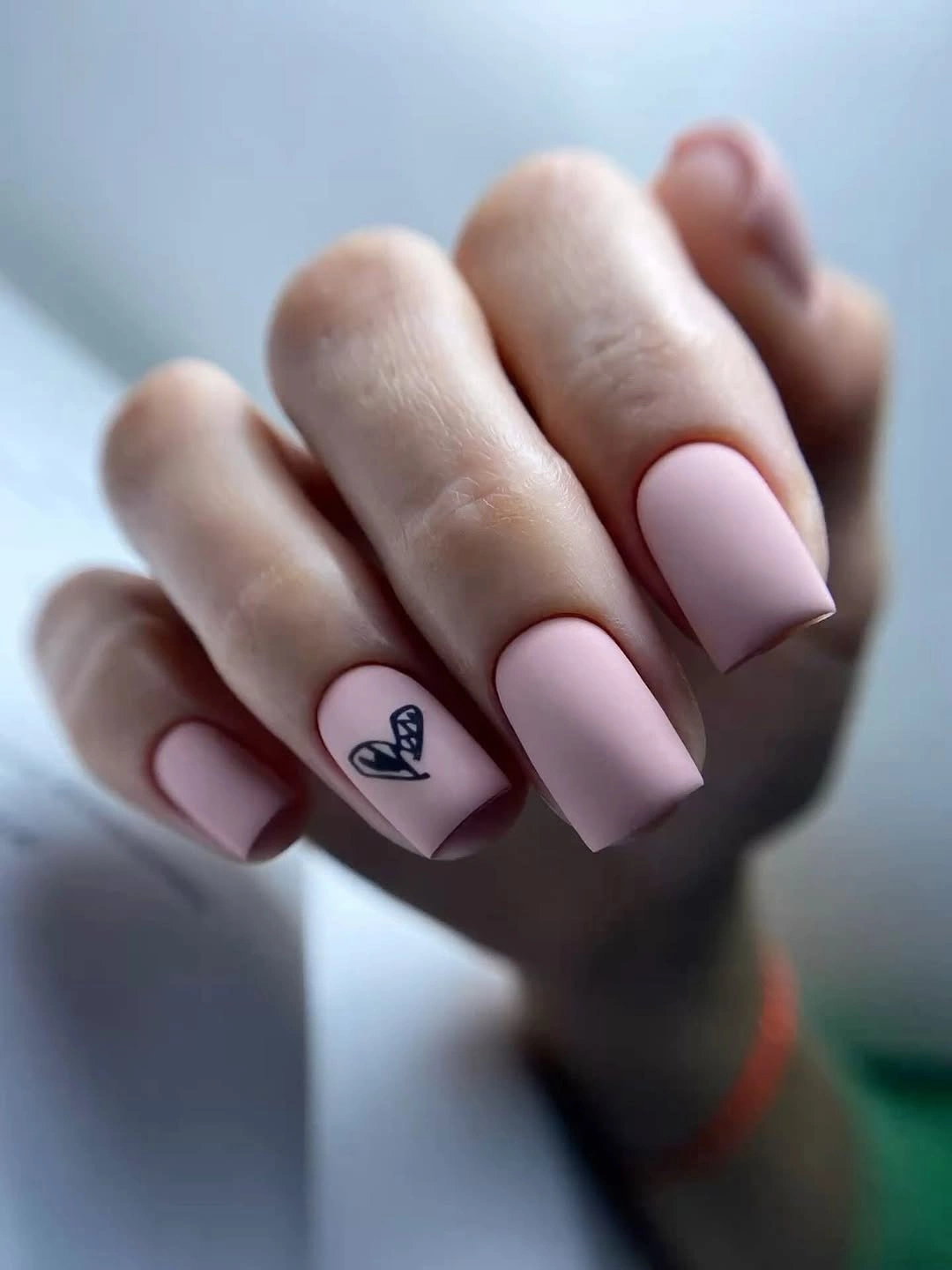 Medium pale pink square nails with one tiny outlined heart