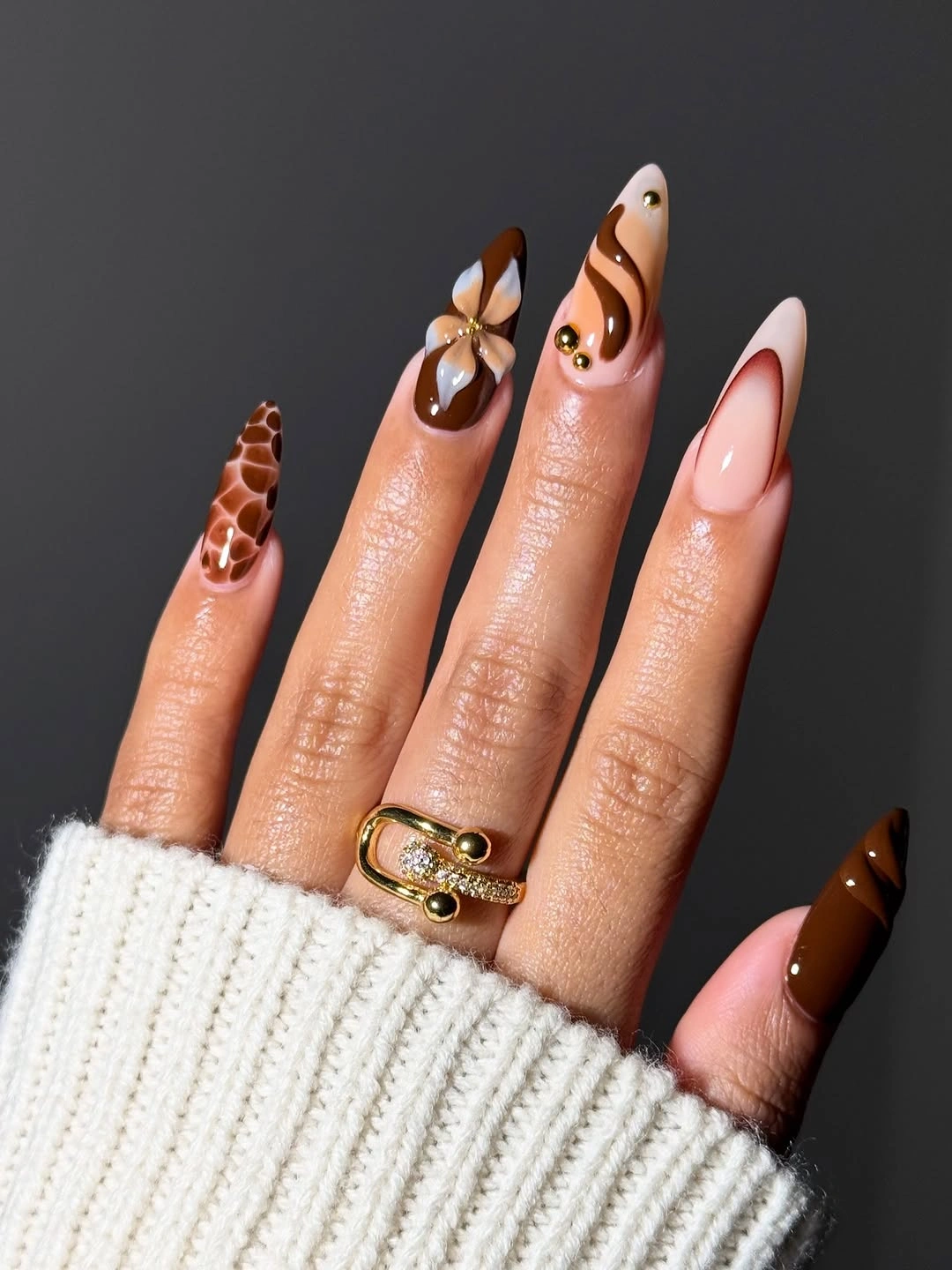 Warm brown almond nails with botanical accents