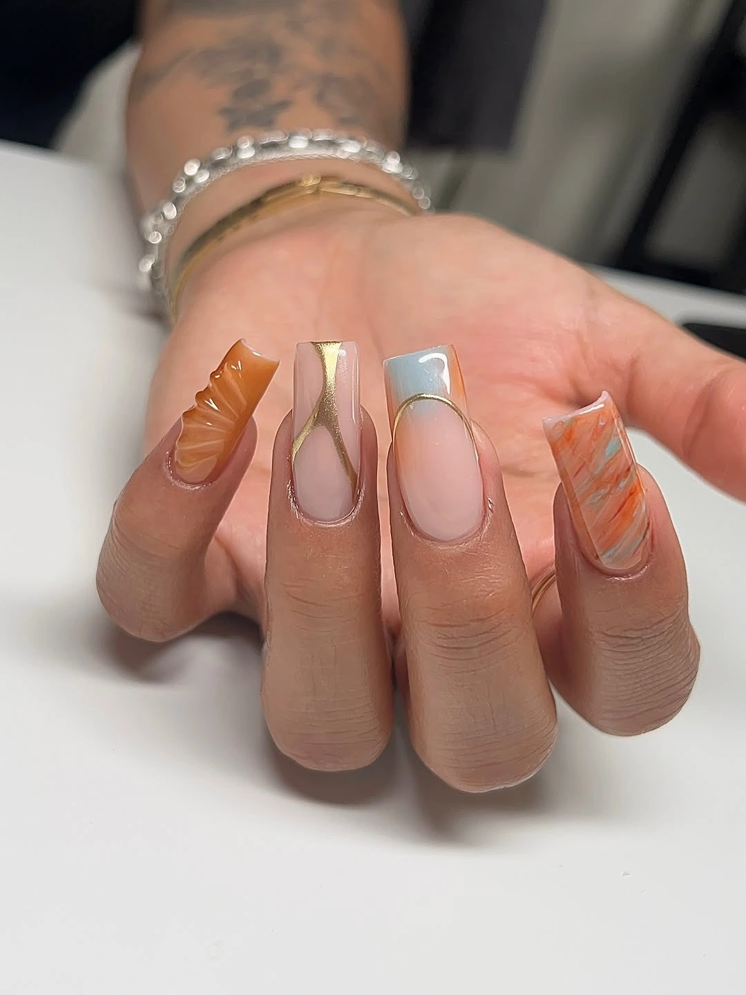Olive amber and plum almond nails with reflective dots