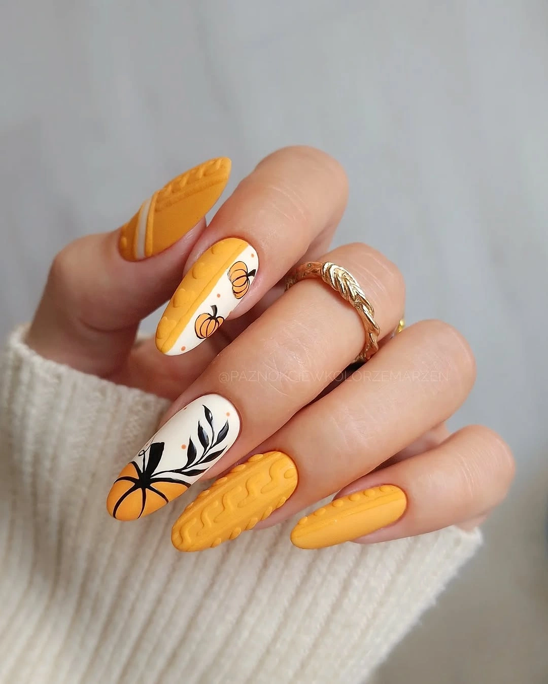 Yellow orange nails with black botanical accent art