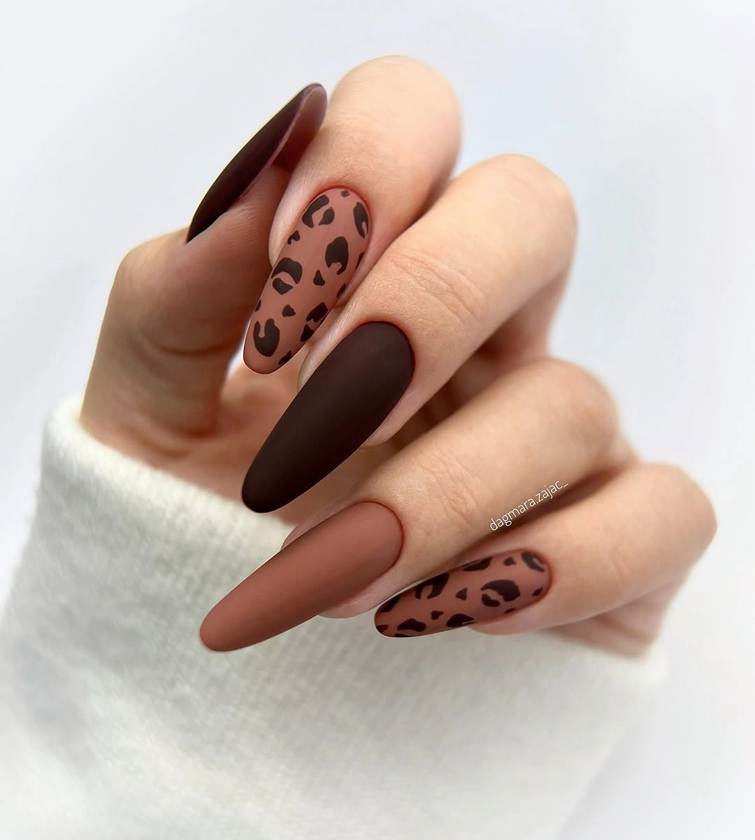 Chocolate almond nails with one leopard accent nail