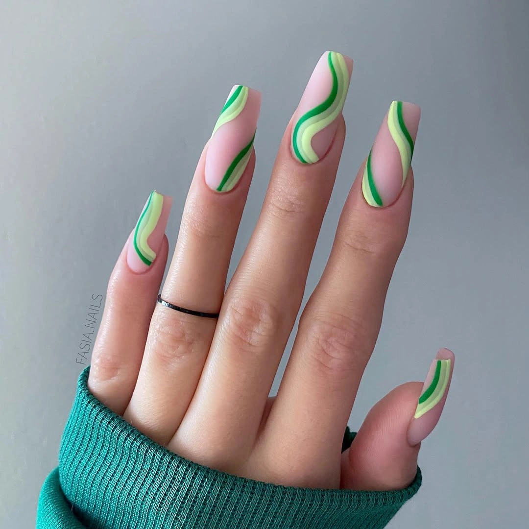 Pink square nails with green wavy line art