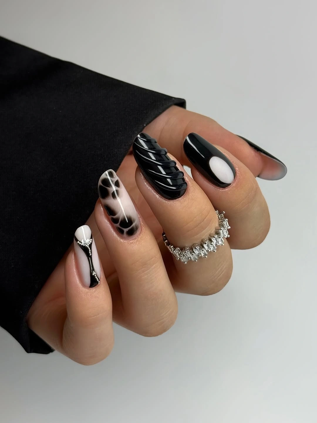 Glossy black and white manicure with smoky accents