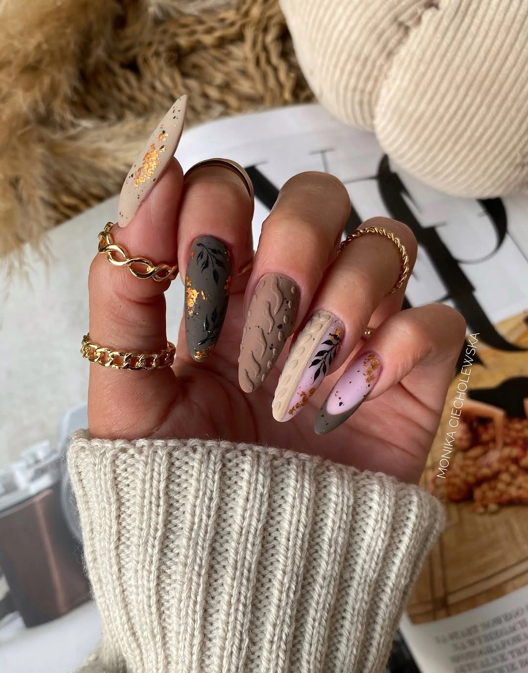 Neutral almond nails with leaf art and texture
