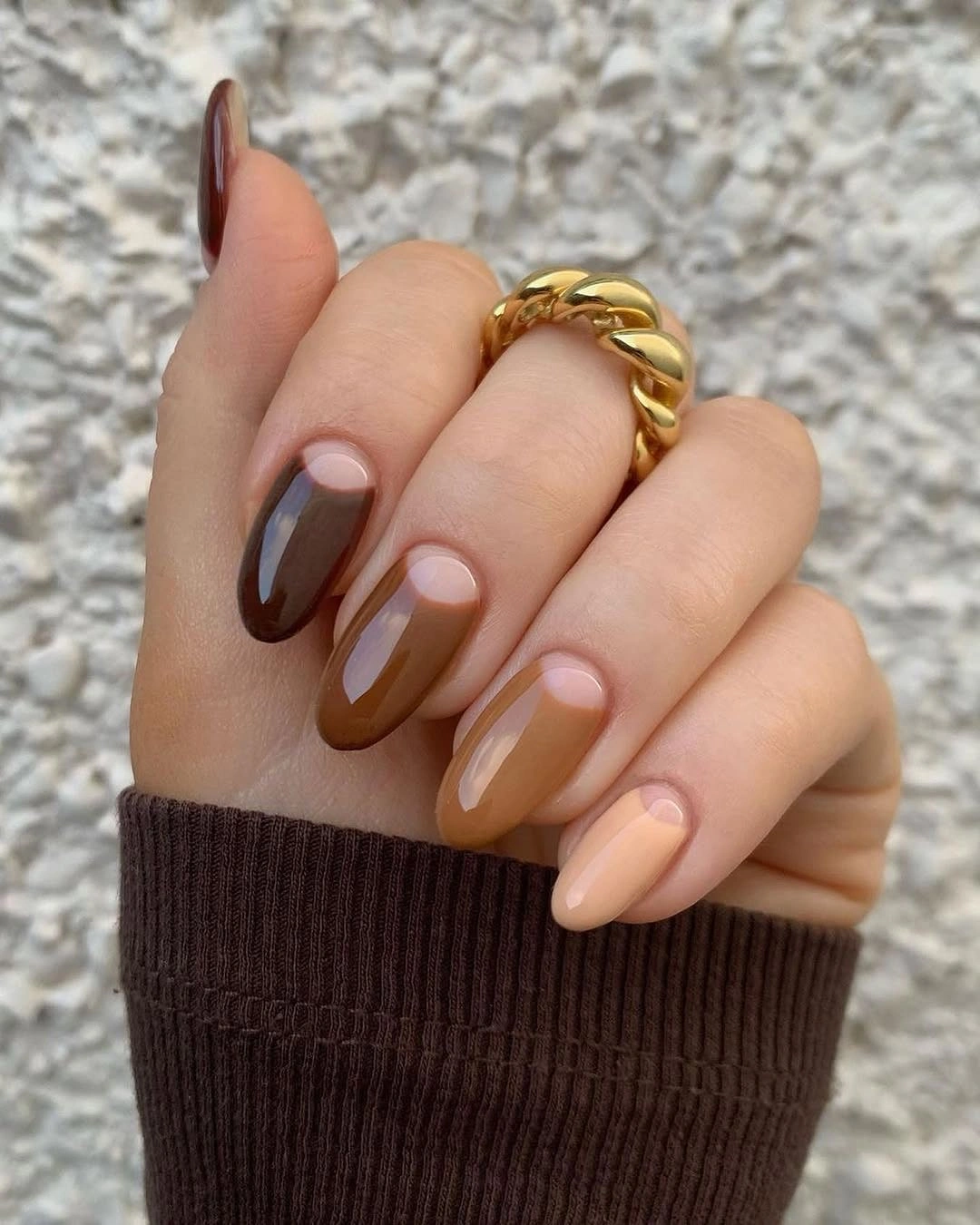 Brown almond nails with rounded half moon spaces