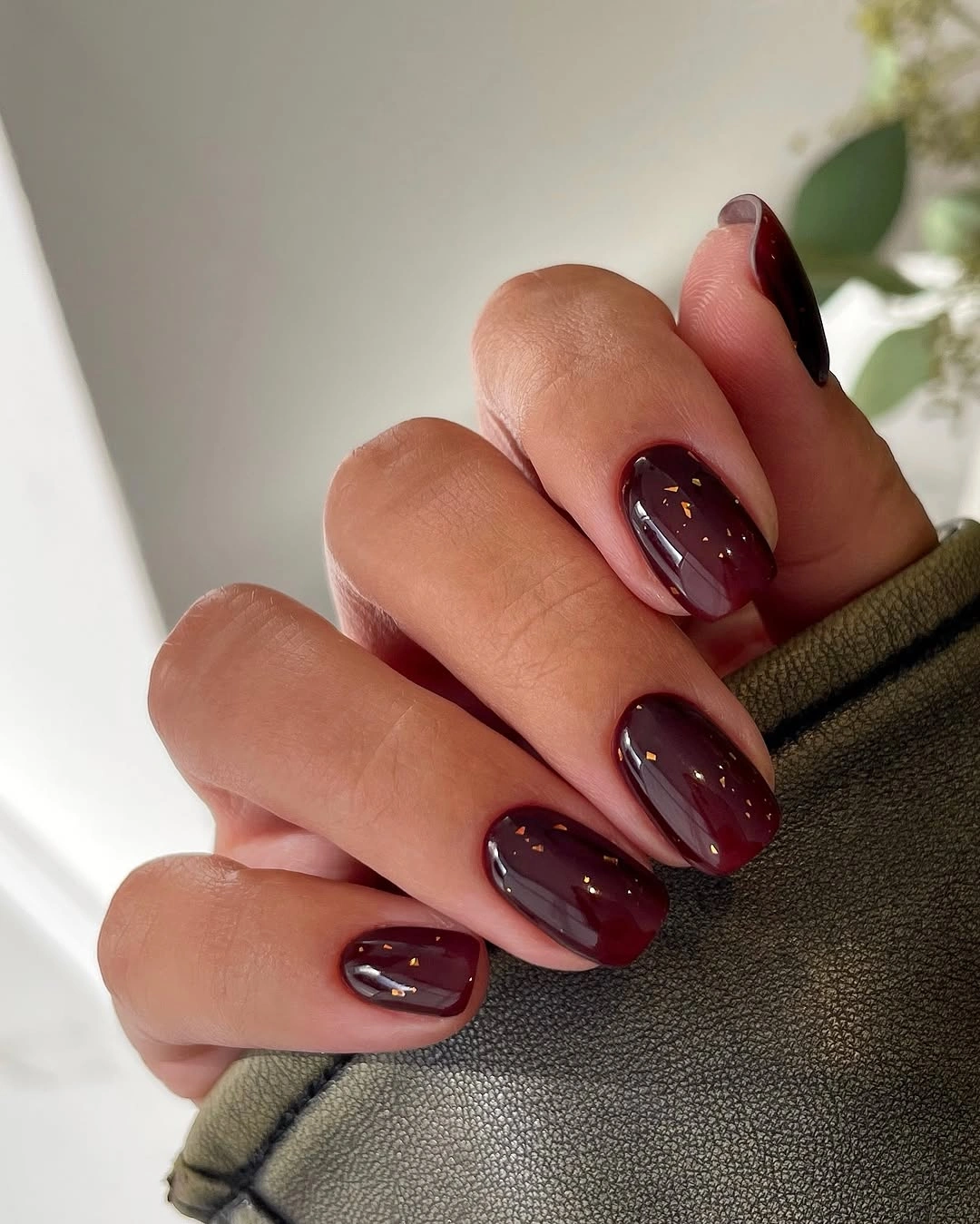 Medium almond glossy plum nails with tonal curved lines