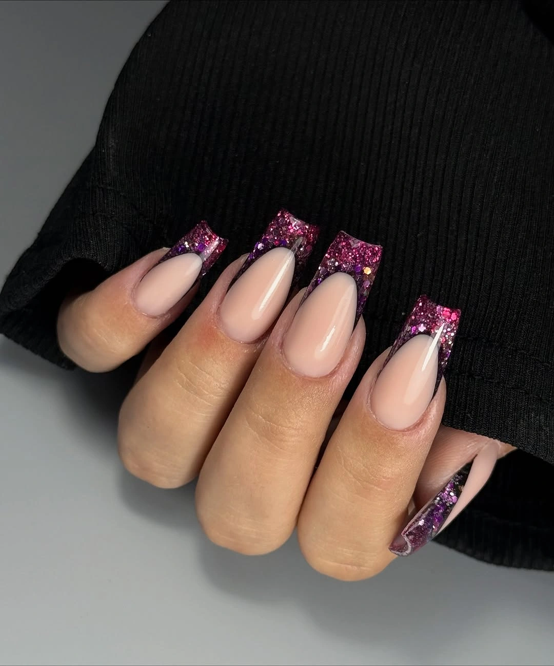 Medium almond nude nails with purple glitter French tips