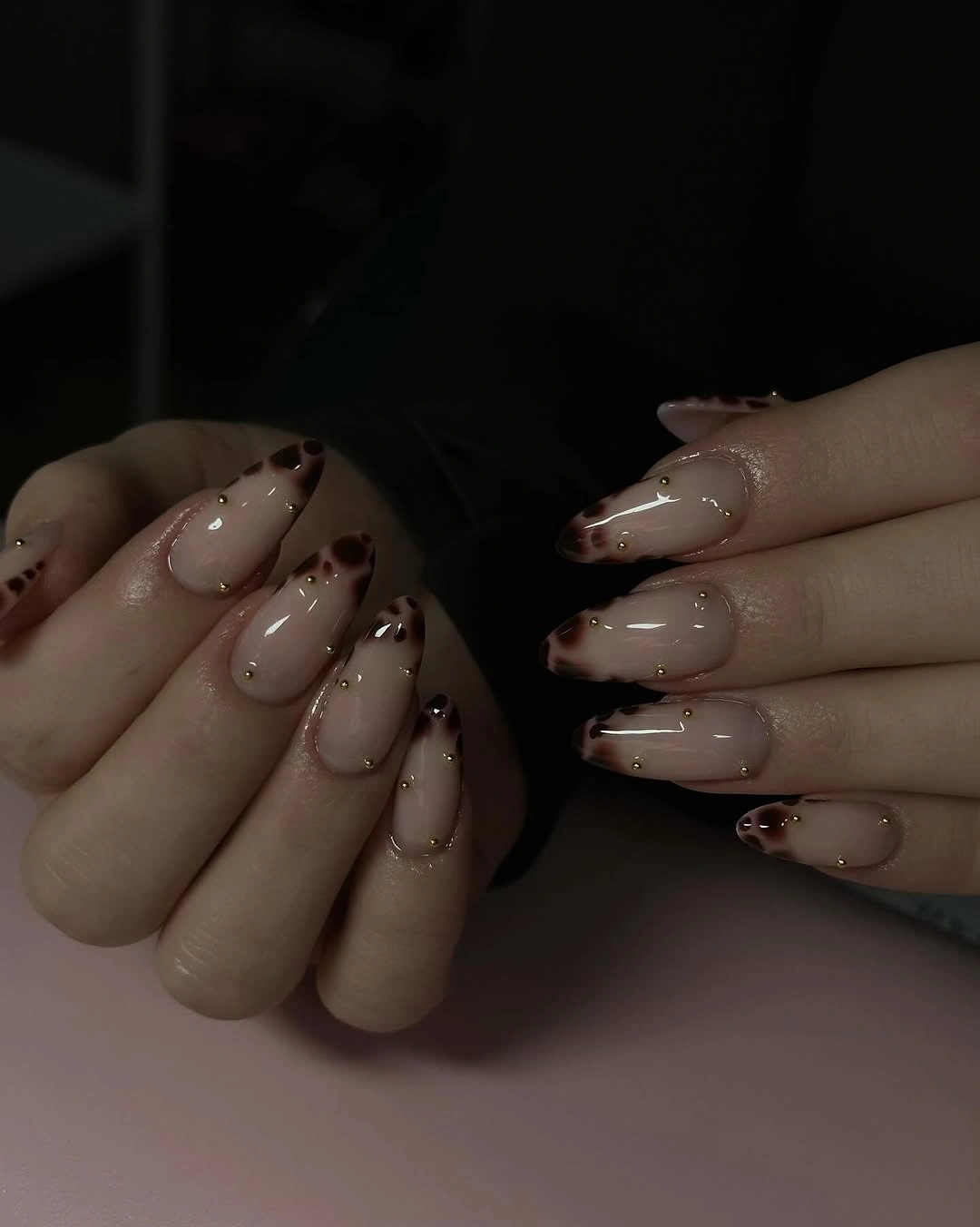 Medium almond sheer nude nails with minimal brown line accents