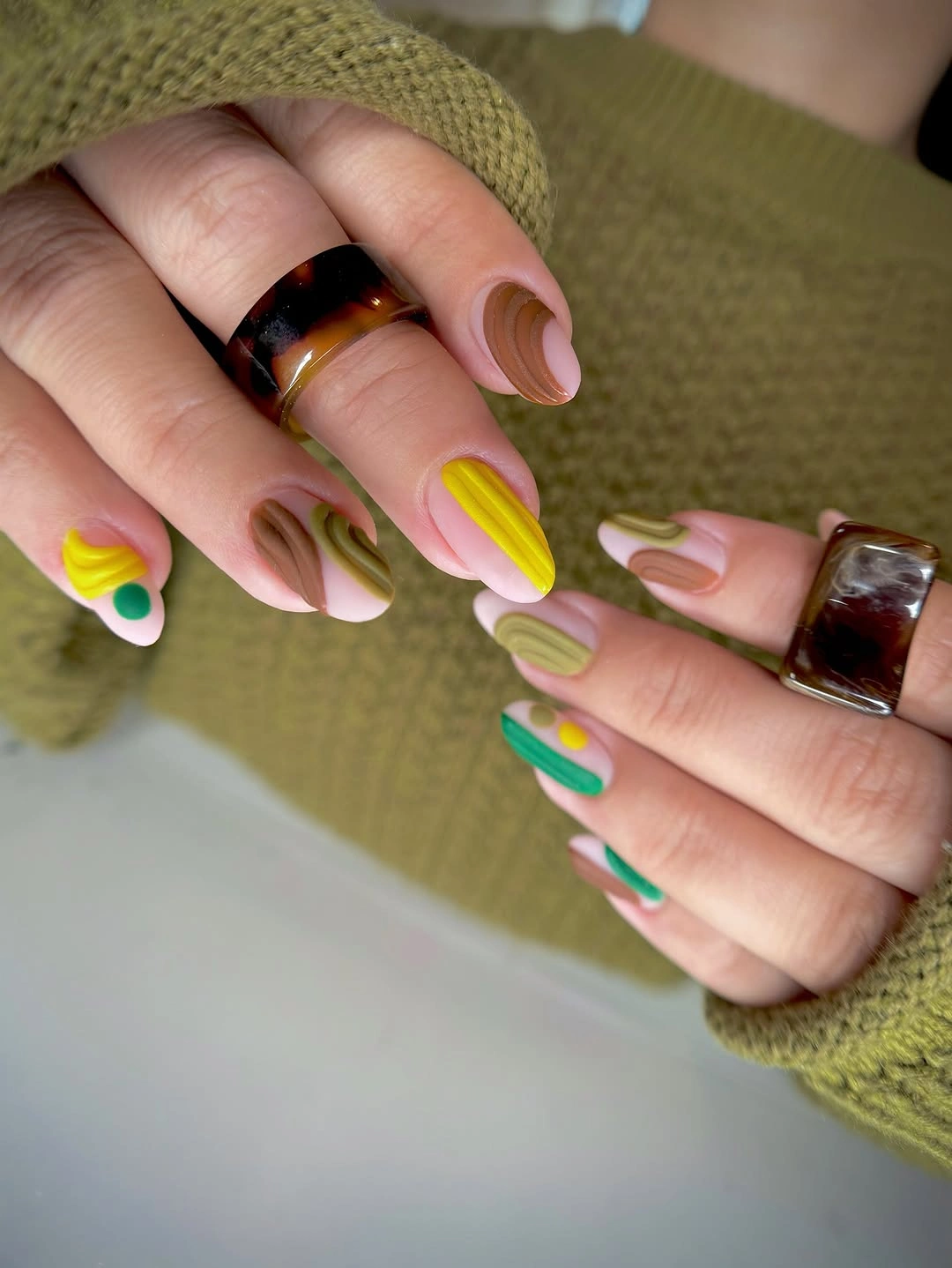 Medium almond nails with pastel pink sage yellow and teal tips